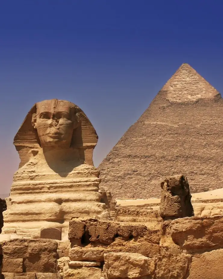 The Great Sphinx sits in profile before the towering Pyramid of Khafre