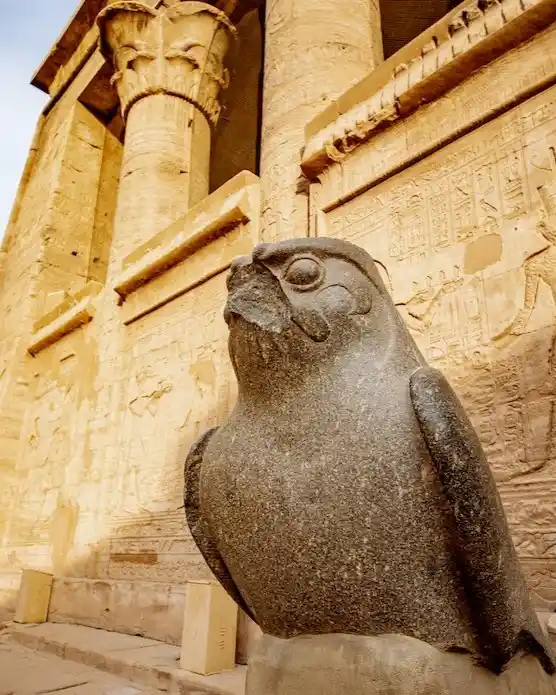 Statue of the falcon god Horus stands guard outside of the Temple of Edfu