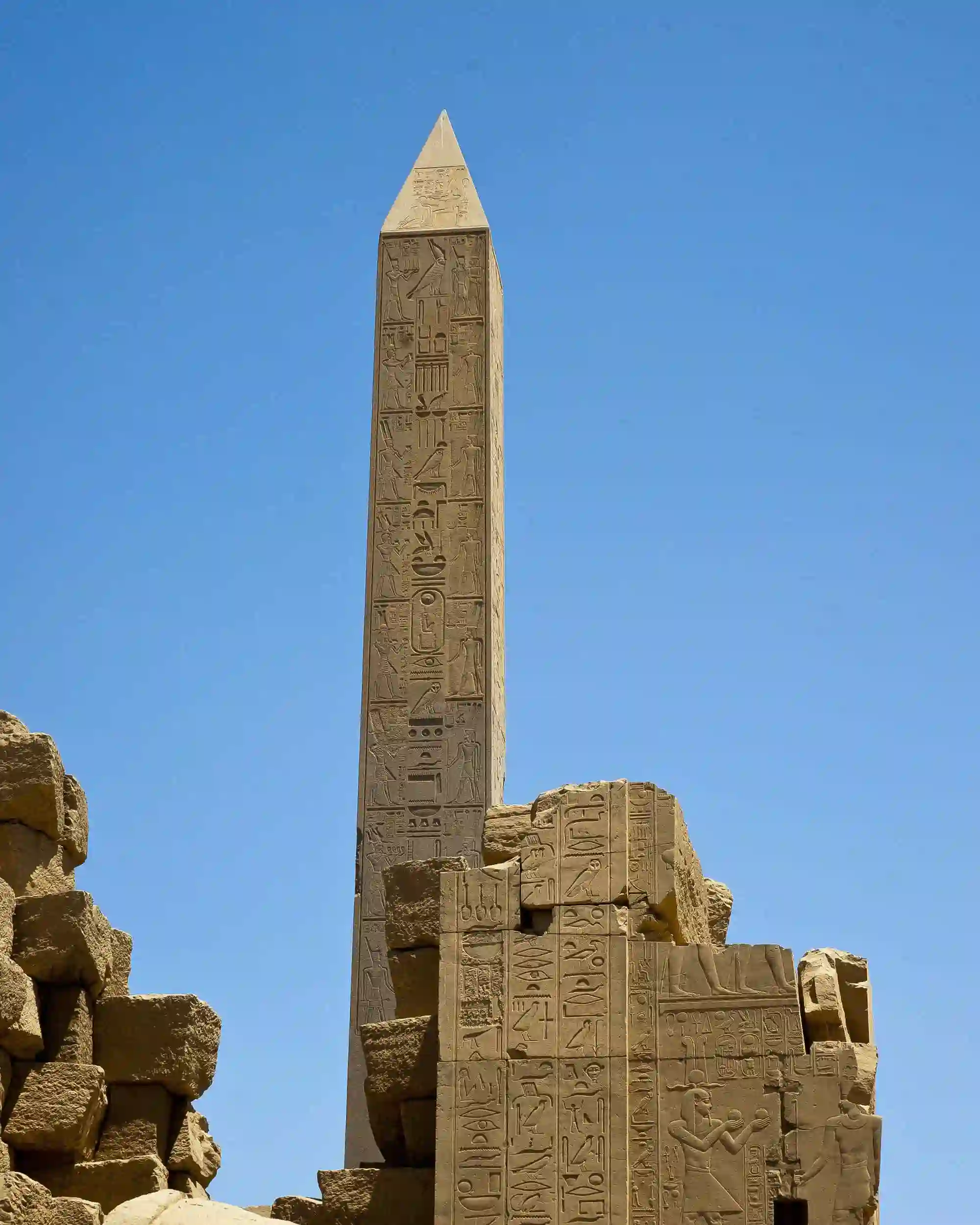 Ancient stone obelisk etched with deep hieroglyphs