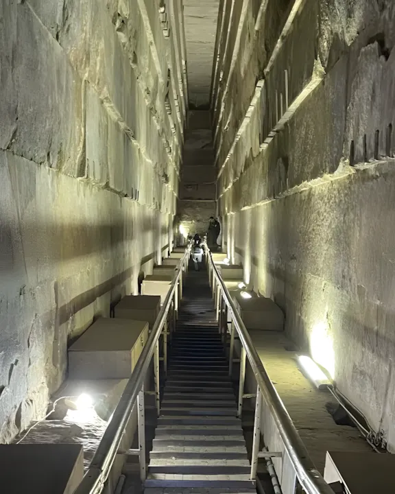 Wooden staircase ascends through the Grand Gallery inside the Pyramid